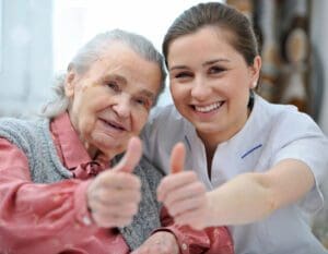 A woman and an old lady giving thumbs up