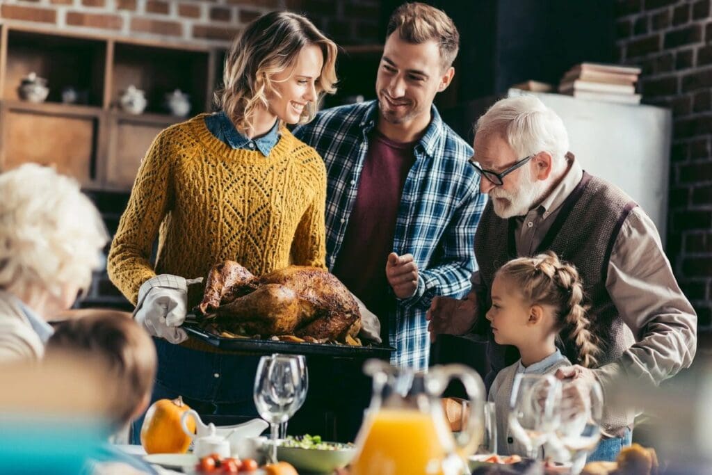 A family is gathered around the table for thanksgiving dinner.