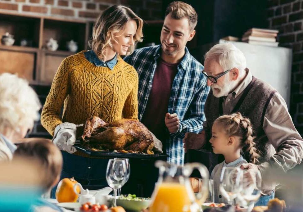 A family is gathered around the table for thanksgiving dinner.